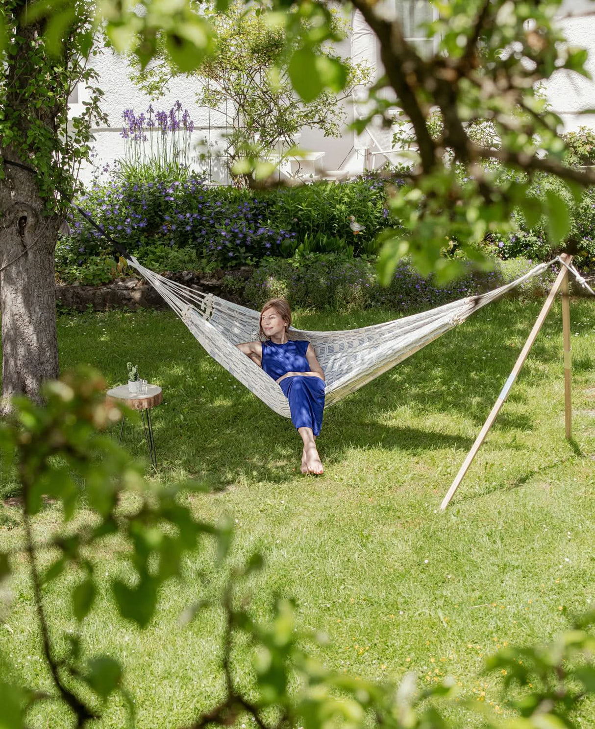 Woman relaxing in a hammock in a garden setting