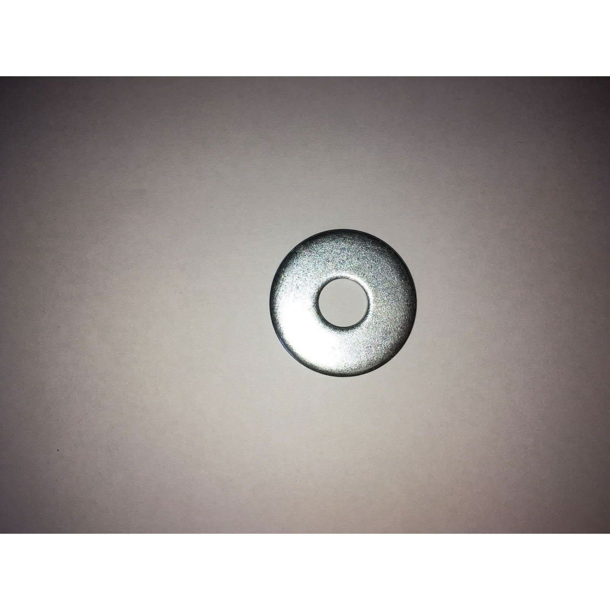 Metal washer on a grey background