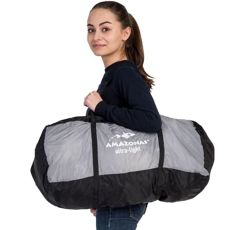 Person holding a large black and grey duffel bag with 'Amazonas' branding on a white background