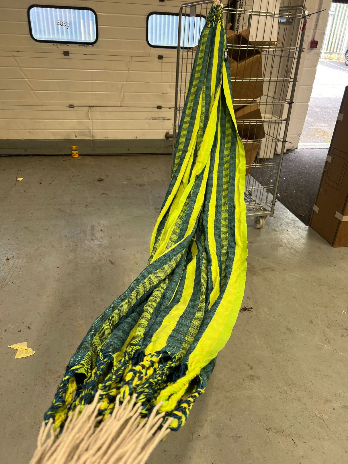 Yellow and green safety net draped over a staircase in an indoor setting