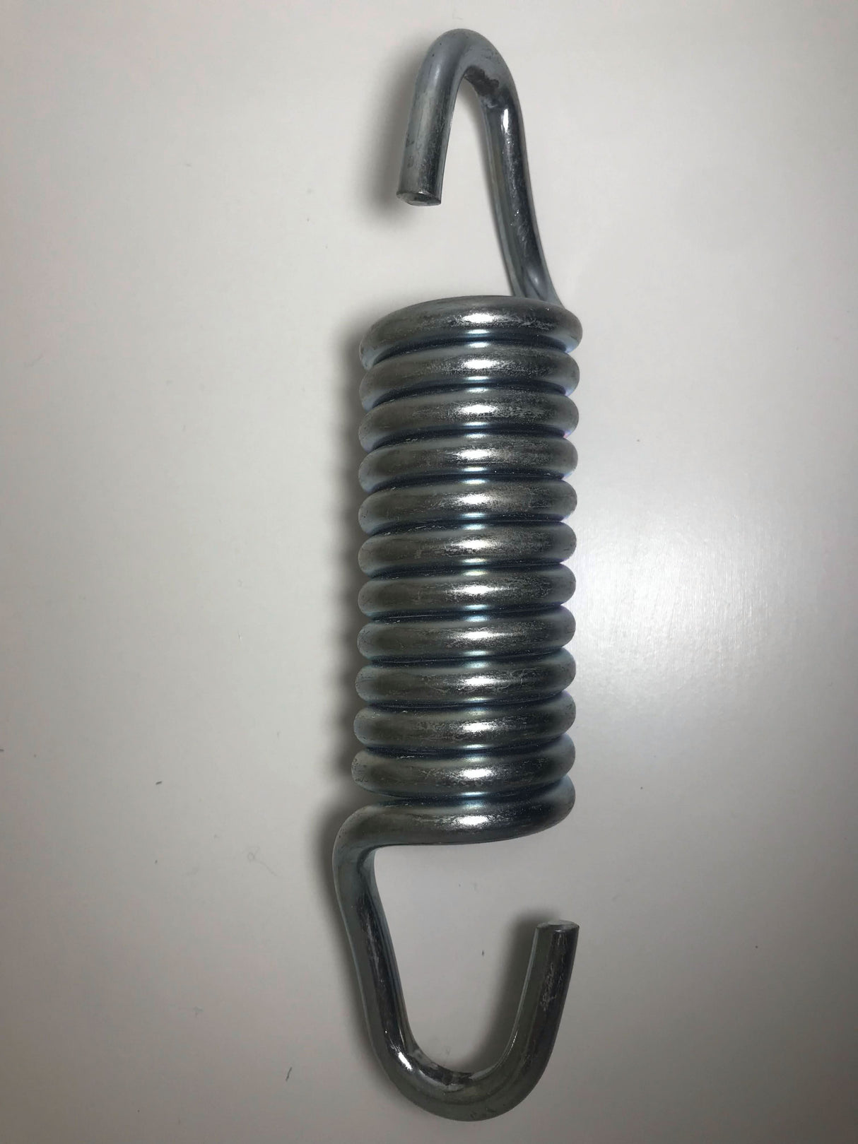 Metal spring with hooks on a white background