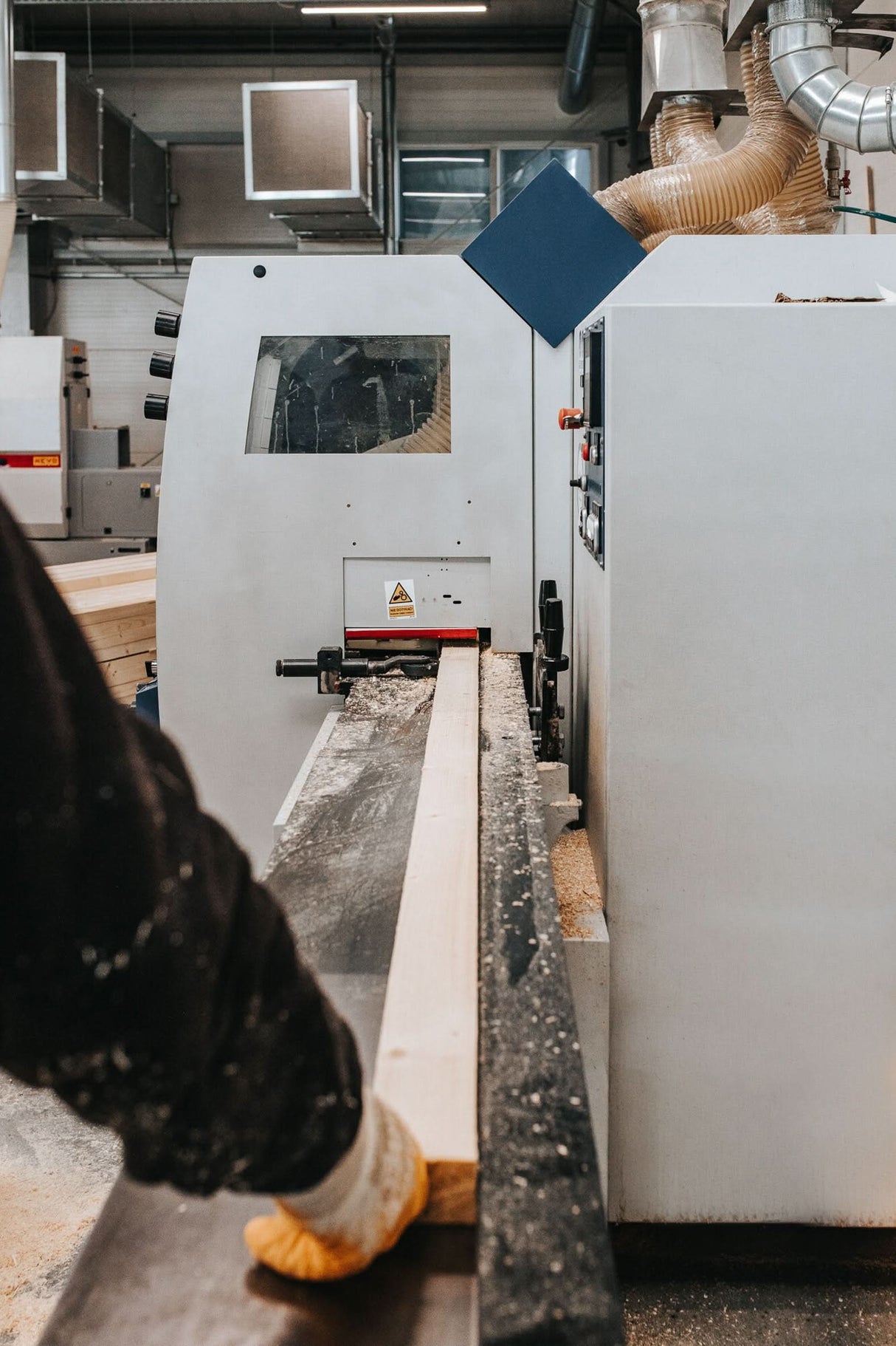 Person operating a CNC machine in a factory setting