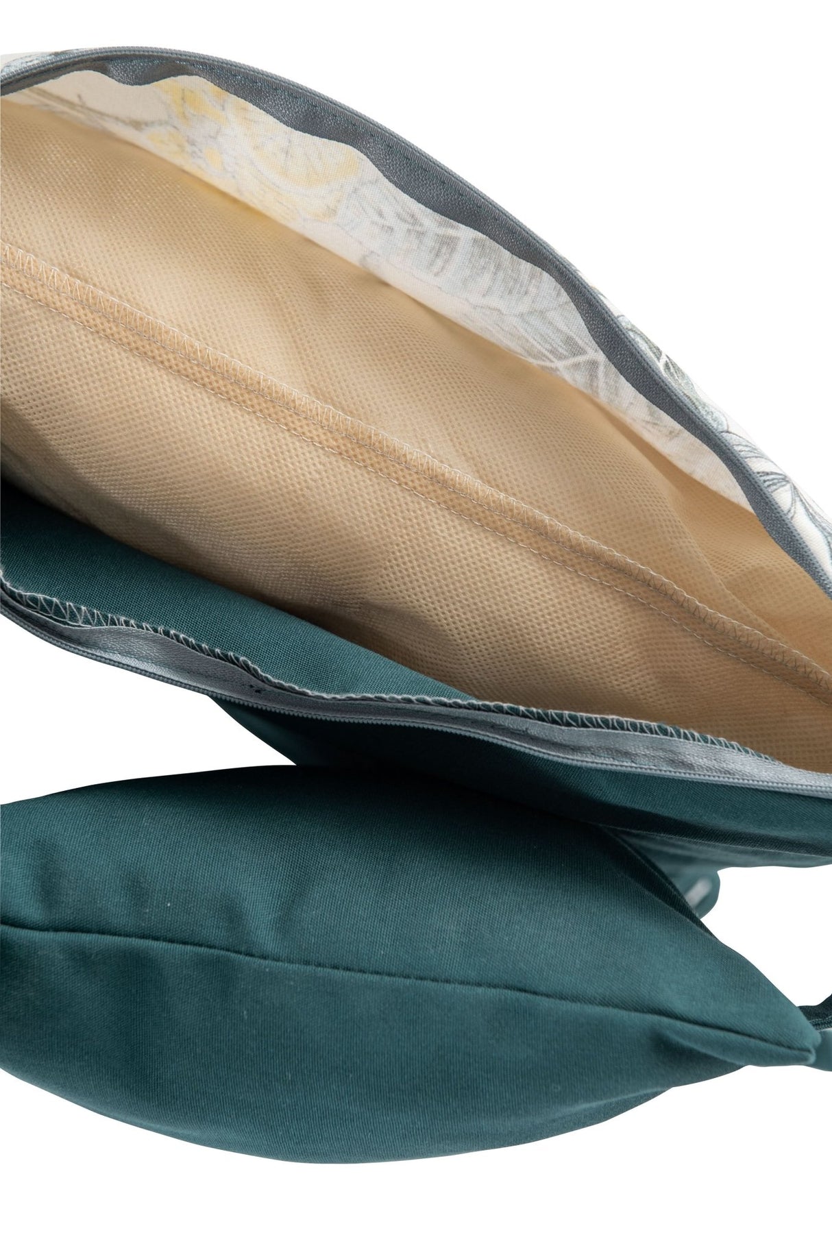 Close-up of a teal pillow with a beige cushion on a white background