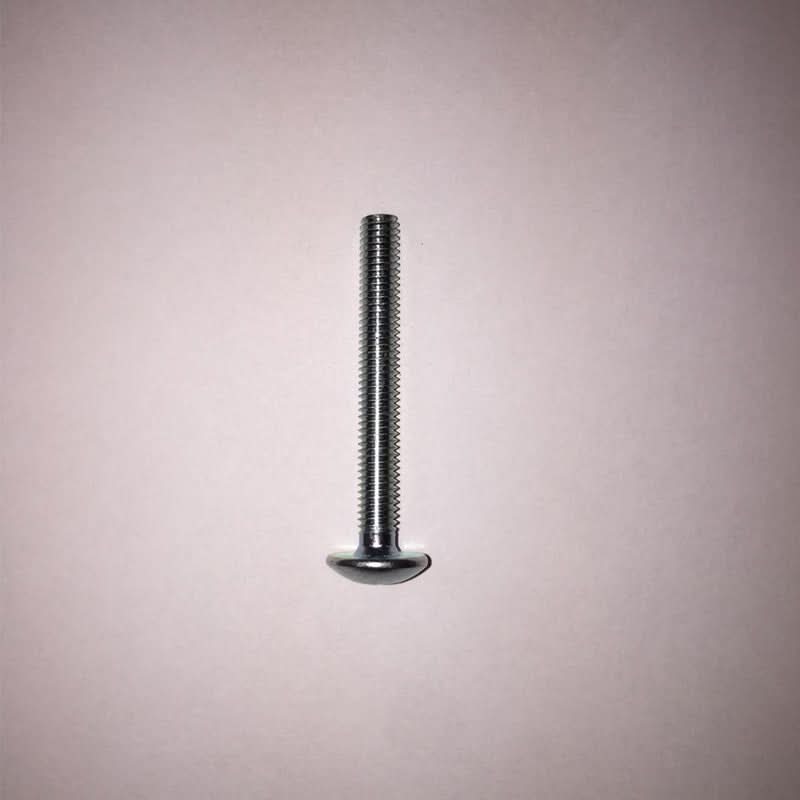 Metal screw on a pink background