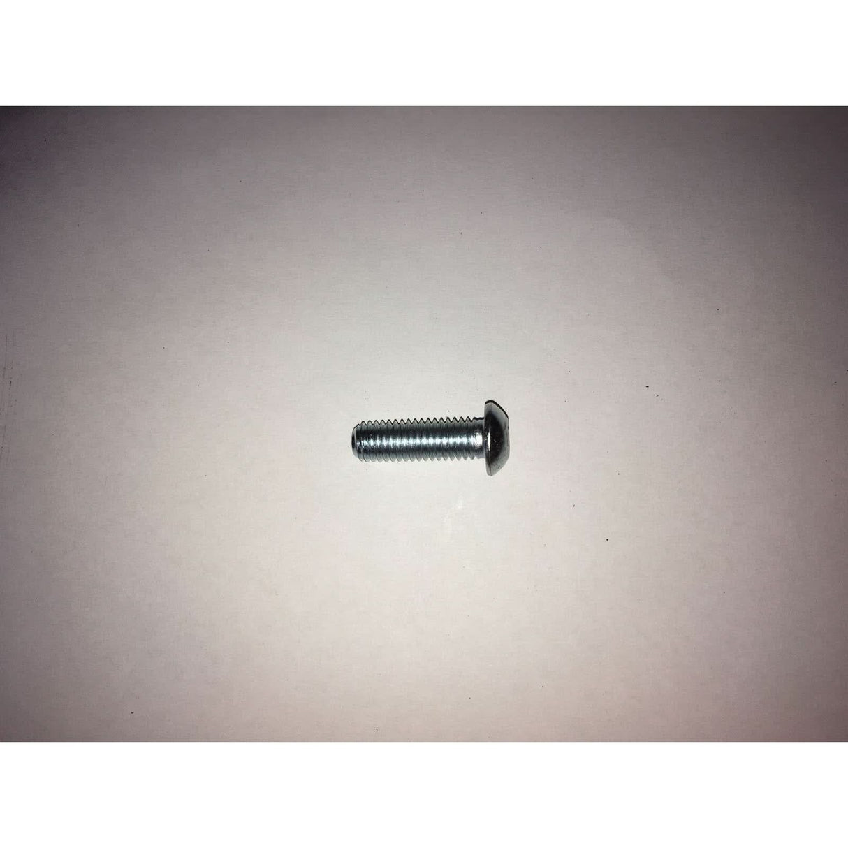 Metal screw on a grey background