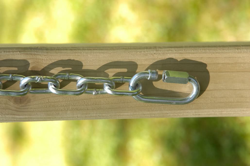 Metal chain attached to a wooden post with a blurred green background