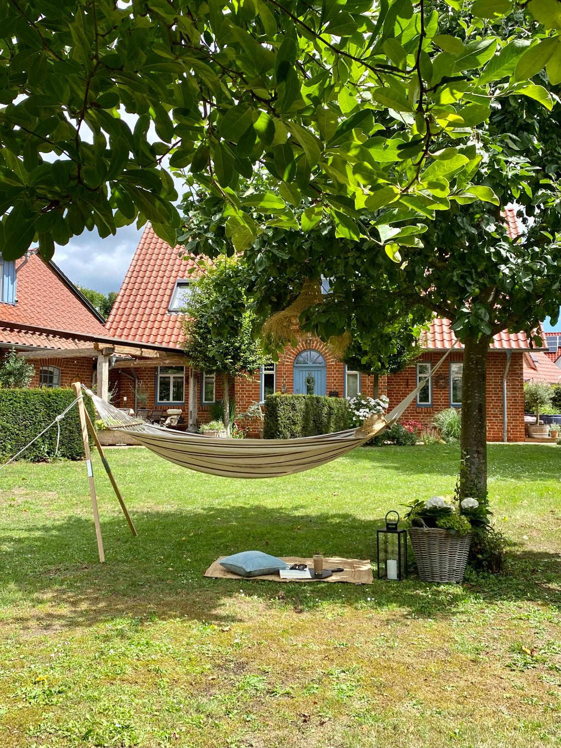 Hammock in a garden with a house in the background