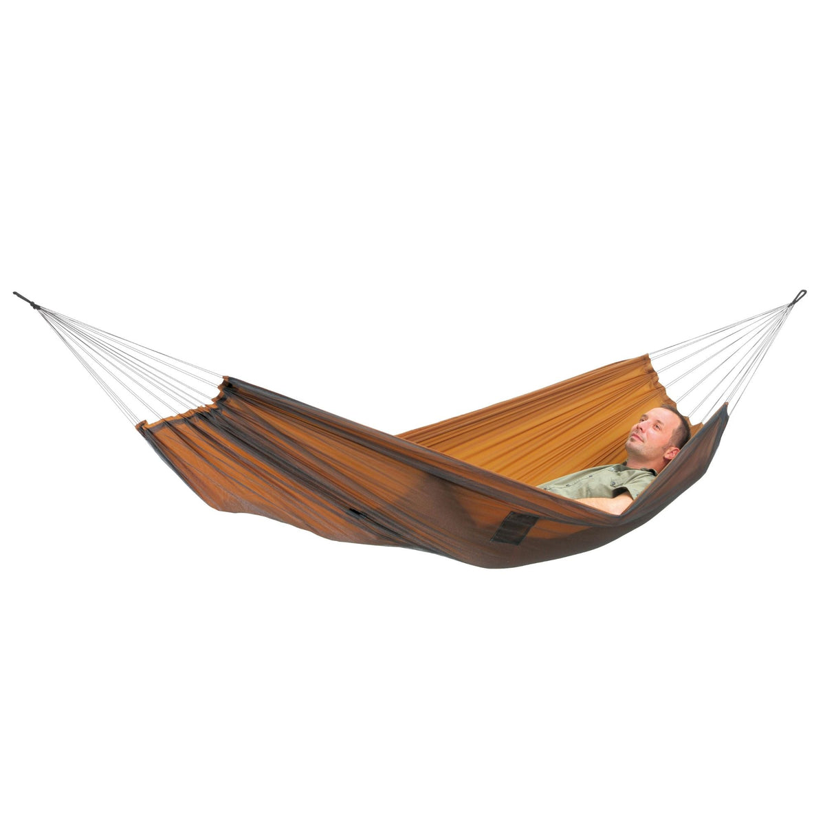 A brown travel hammock suspended with a man lying inside on a plain white background.