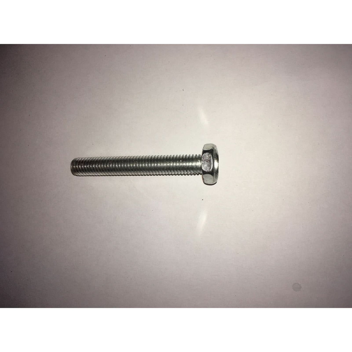Metal screw on a grey background