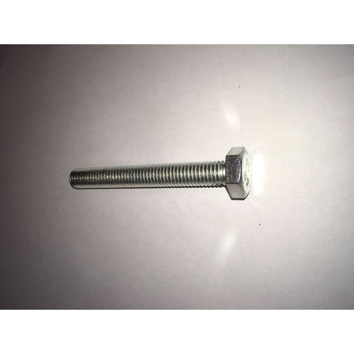 Metal screw on a grey background