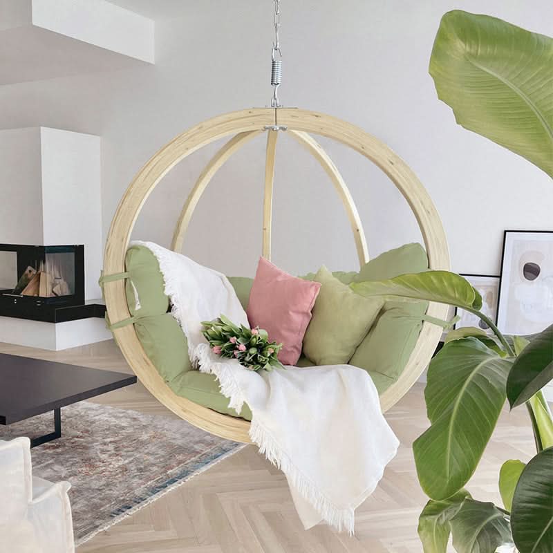 Hanging chair with cushions in a modern living room setting