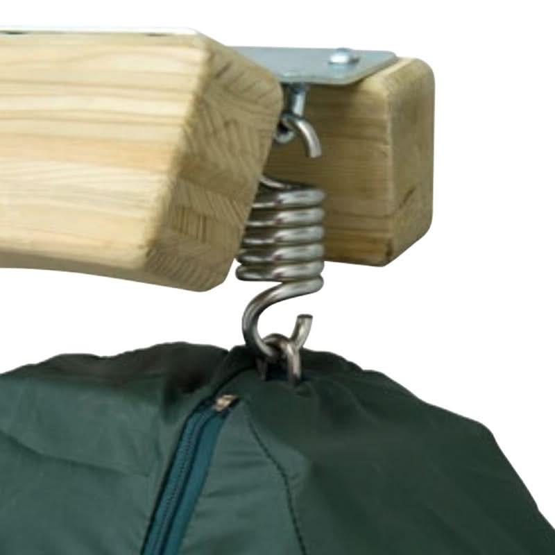 Wooden block with metal spring attached to a green jacket on a white background