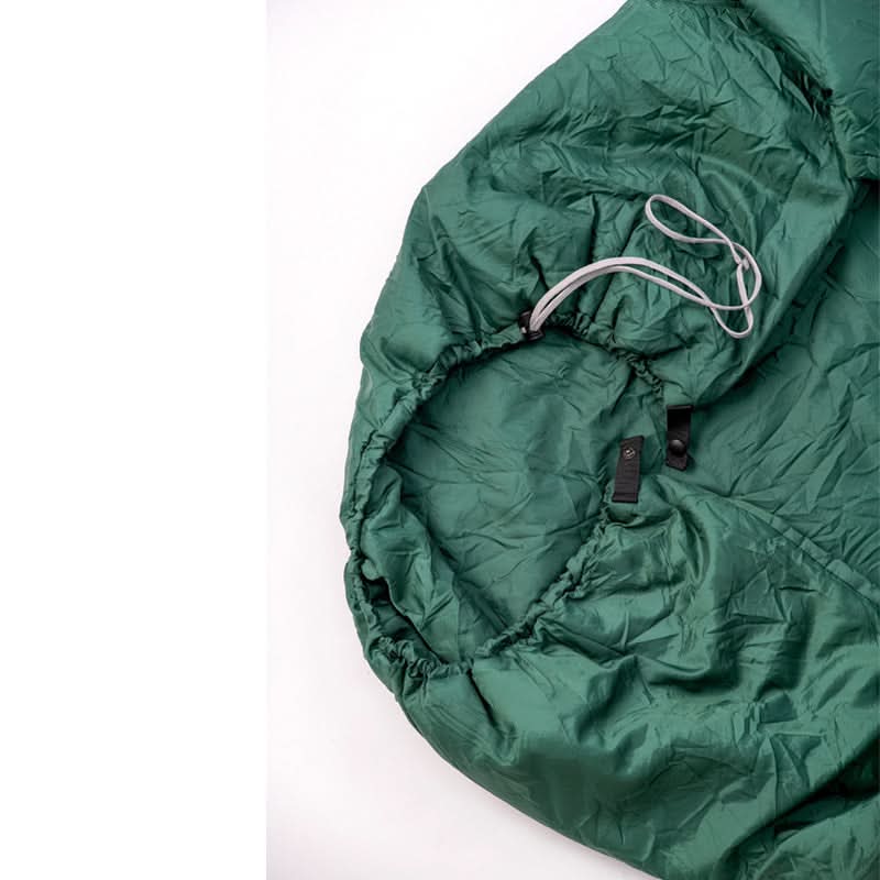 Green sleeping bag on a white background