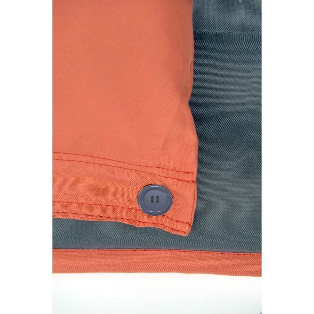 Close-up of an orange and grey jacket with a button on a white background