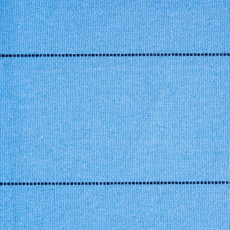 Close-up of blue fabric with a horizontal seam