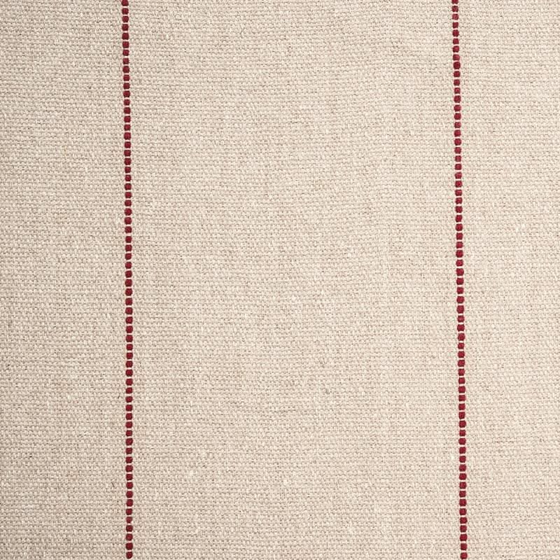 Textured fabric with red stitching on a beige background