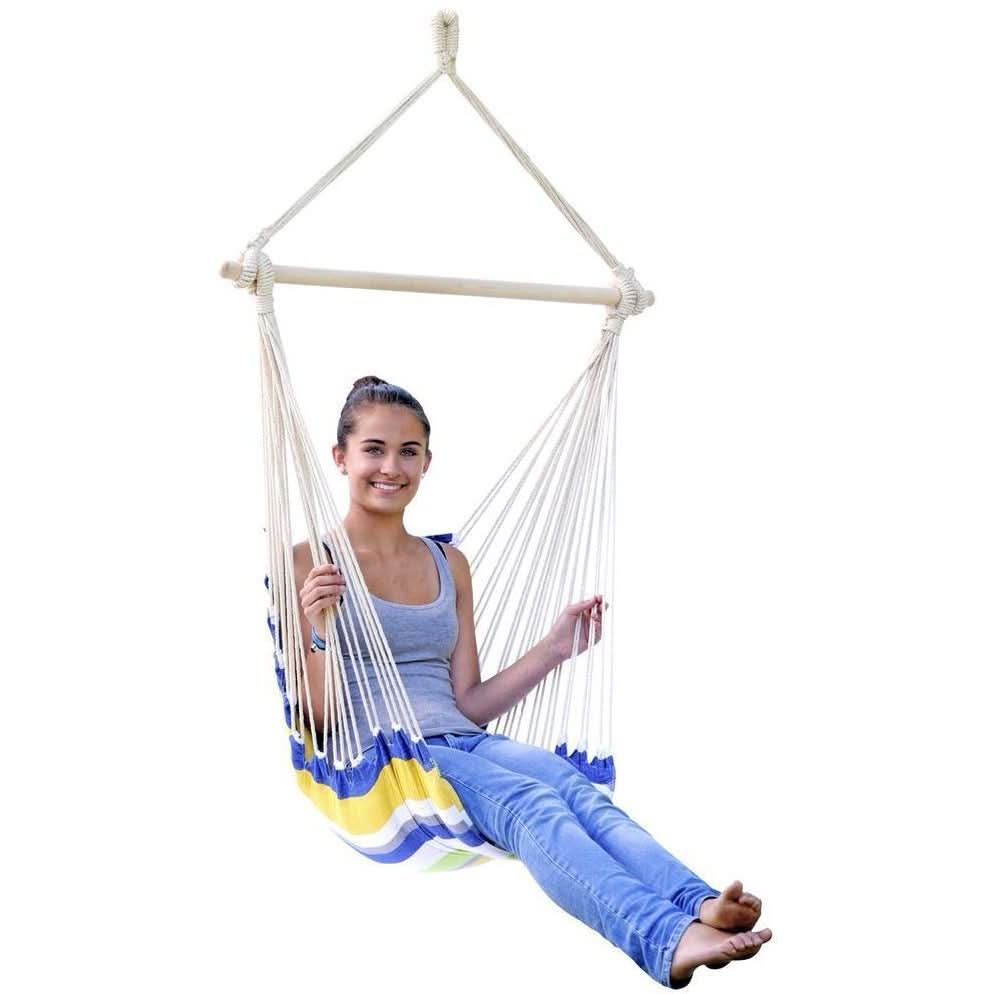 Person sitting in a colourful hammock chair on a white background