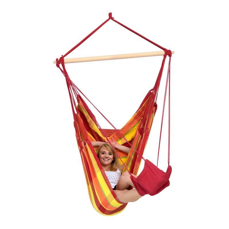 Colourful hammock chair with a person sitting inside on a white background