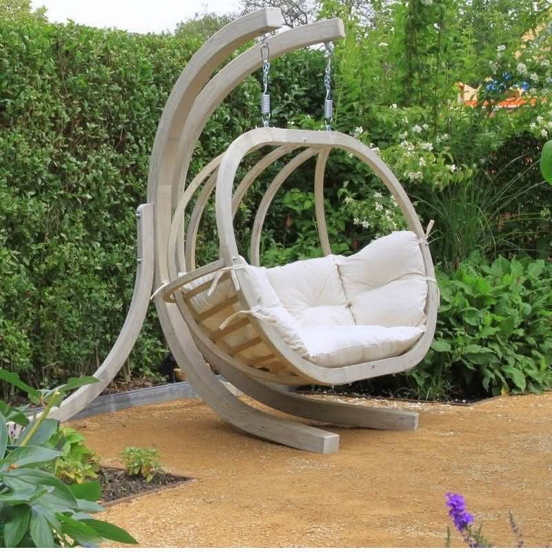 Modern hanging chair with cushion in a garden setting