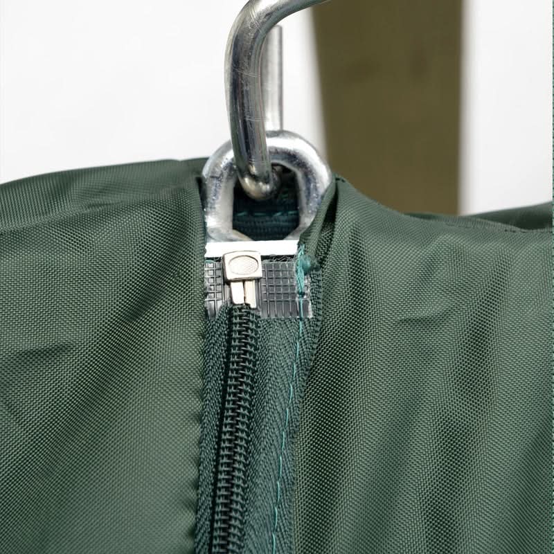 Close-up of a green bag with a zipper and metal clasp on a white background