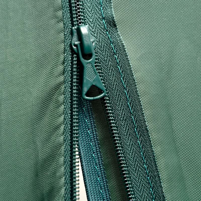 Close-up of a green zipper on a green fabric background