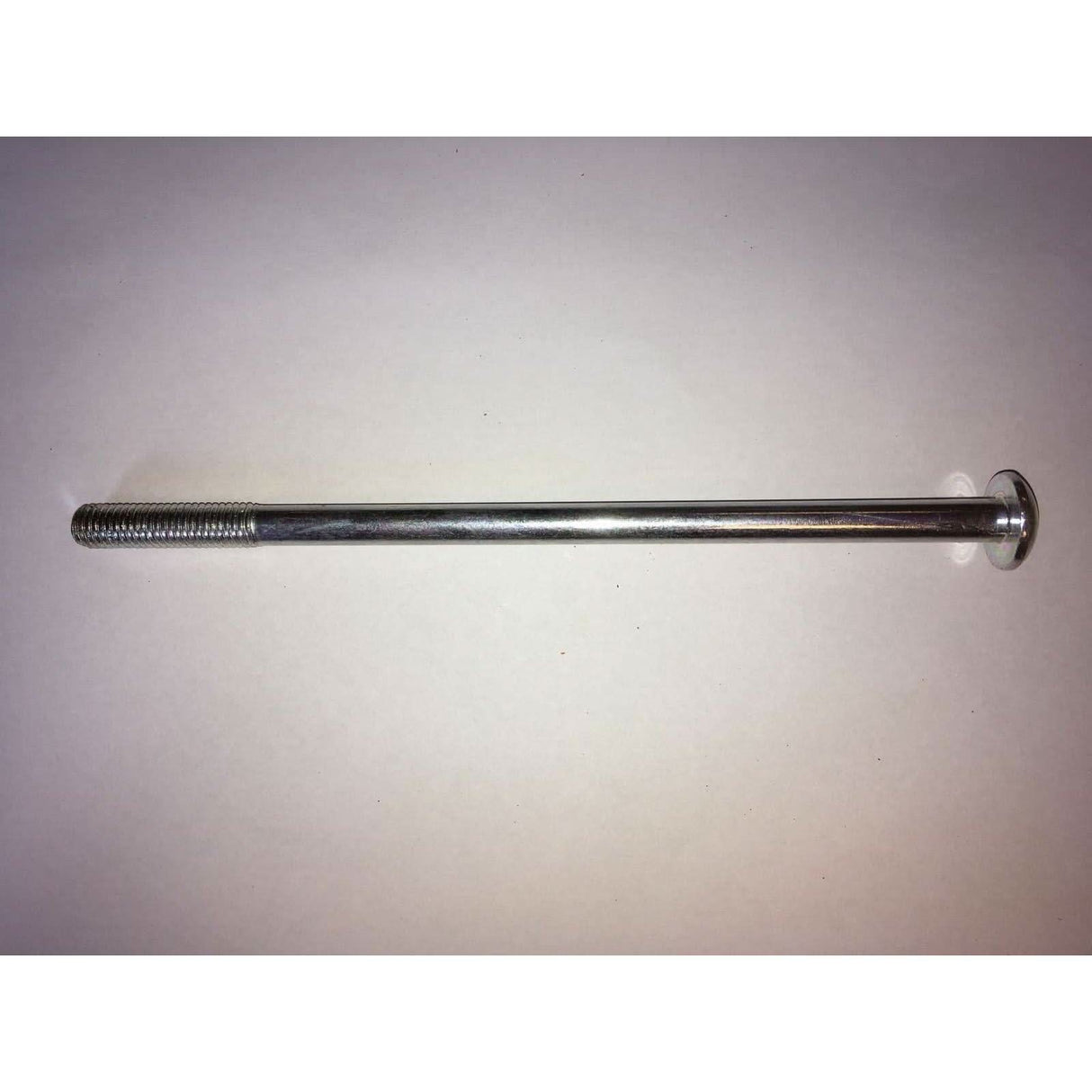 Metal rod with threaded end on a light grey background
