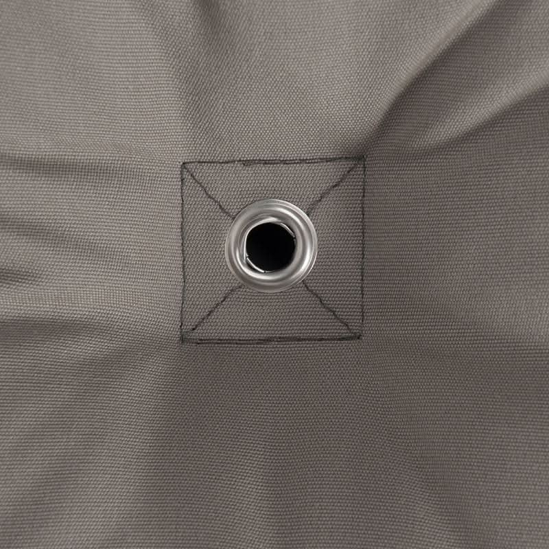 Close-up of a grey fabric with a grommet hole.