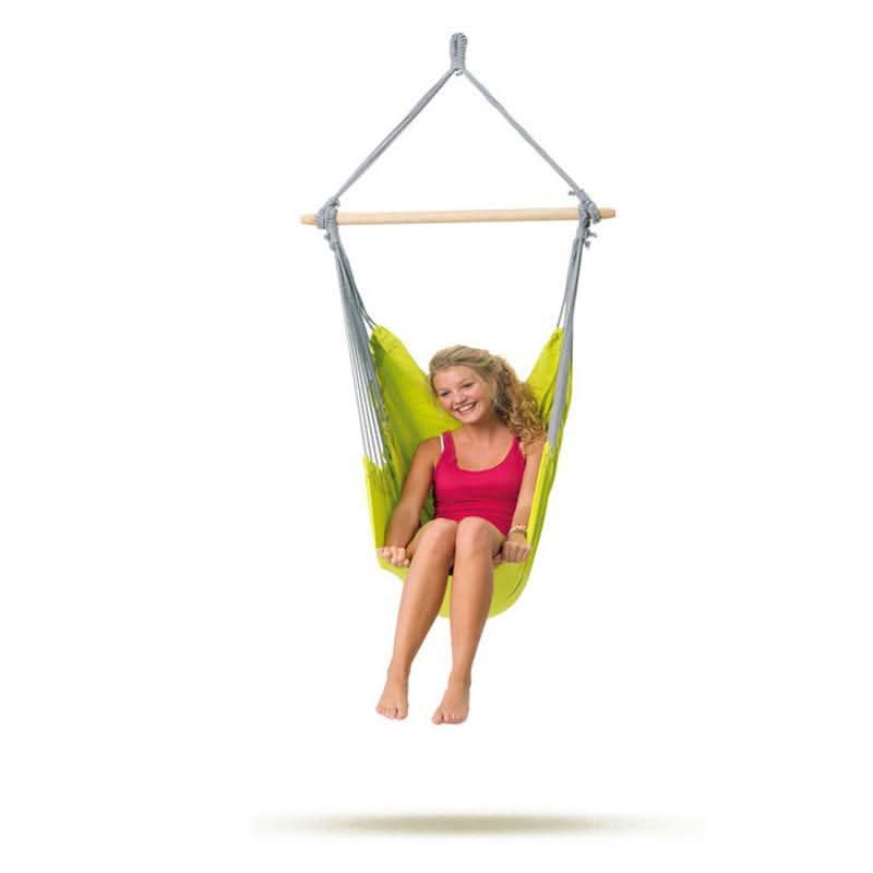 Child sitting in a green and grey hammock chair on a white background