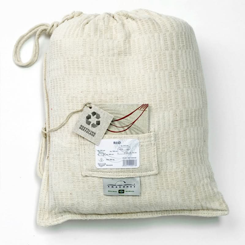 Beige drawstring bag with labels on a white background