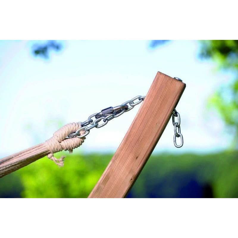Wooden swing with chain attachment against a blurred natural background