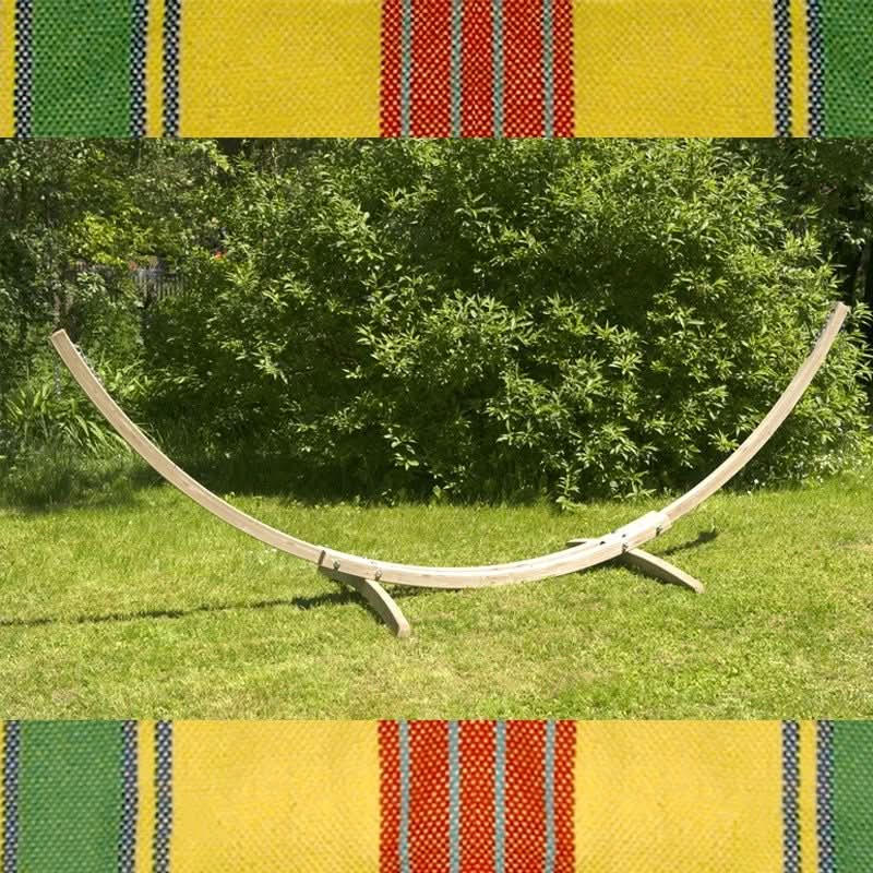 Wooden hammock on grass with colourful striped patterns at the top and bottom