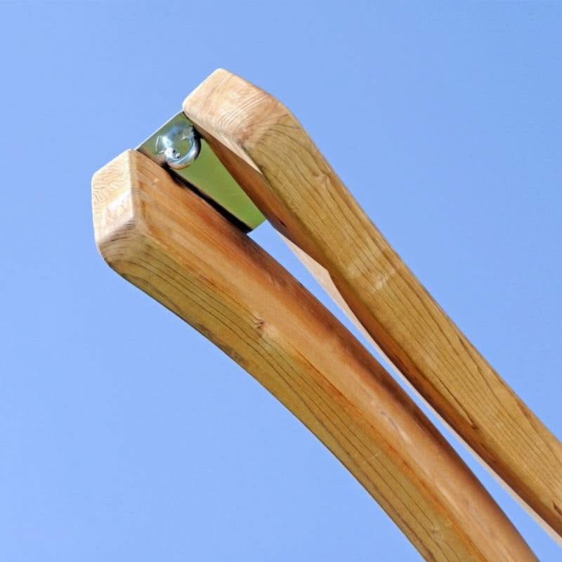 Wooden tent pole with metal clip against a clear blue sky