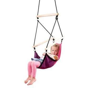 Child sitting in a purple swing with a white background