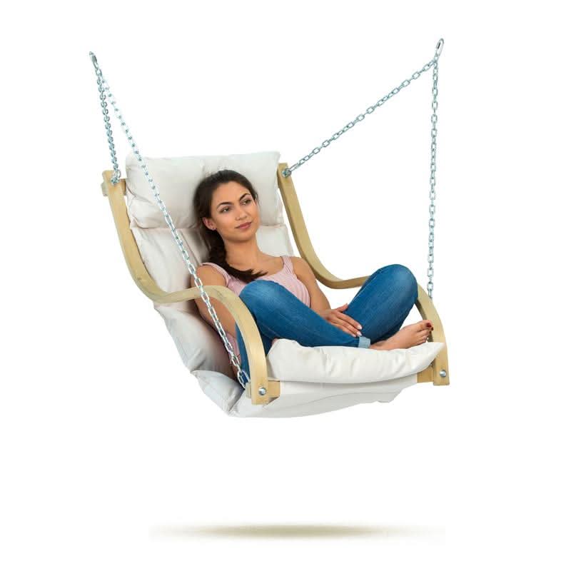 A woman sitting in a white hammock chair with a wooden frame on a white background