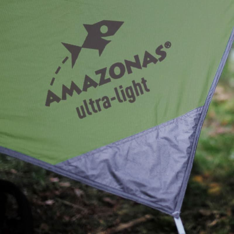 Green tent with 'Amazonas ultra-light' logo in a natural setting