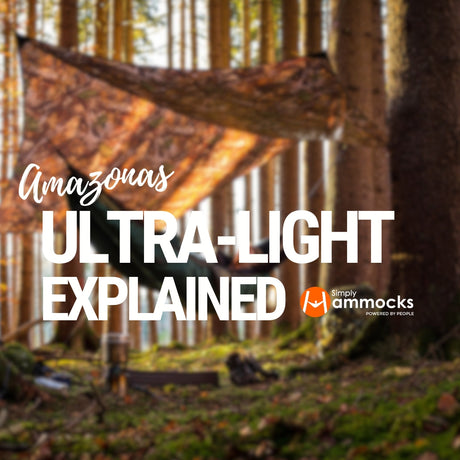 Ultralight hammock, ropes, tarp and underquilt set up in an autumn woodland