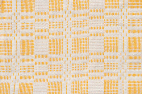 Patterned fabric with yellow and grey checkered design