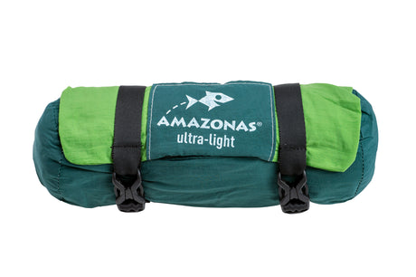 Green and teal sleeping bag with 'Amazonas ultra-light' branding on a white background