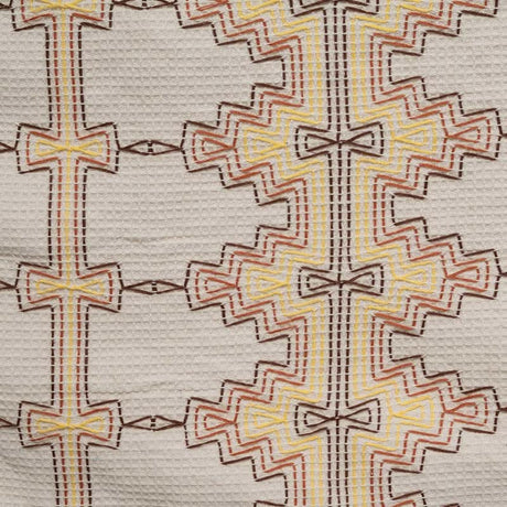 Close-up of a textured fabric with geometric pattern on a beige background