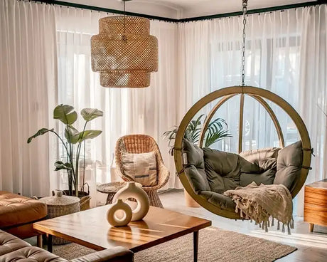Modern living room with a hanging chair, sofa, and decorative elements.
