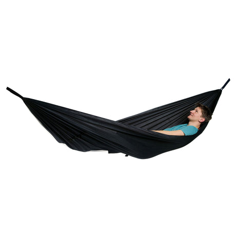 A person lying in a black hammock against a plain white background.