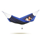 Blue and black hammock with a person inside on a white background