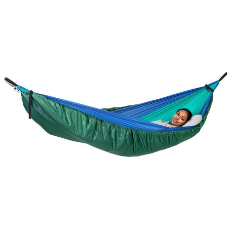 green hammock underquilt below a camping hammock with a person inside on a white background