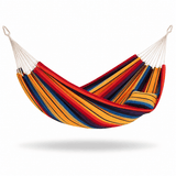 A striped fabric hammock with white suspension ropes and metal hanging rings, shown on a clean white background with a soft shadow underneath. The hammock features diagonal stripes in red, orange, yellow, blue, and black, and includes a matching striped pillow.
