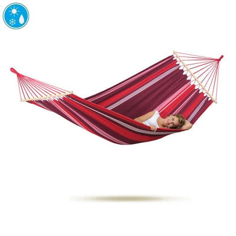 Red hammock with a person lying inside on a white background