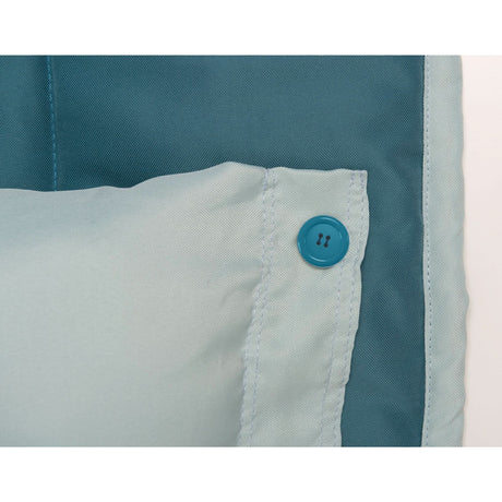 Close-up of a blue button on a garment with teal and white fabric.