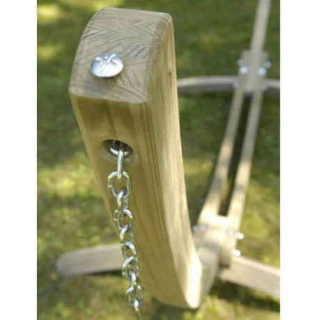 Wooden swing seat with chain on a blurred green background