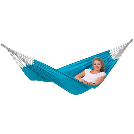 Blue hammock with a person sitting inside on a white background