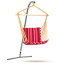 Hanging chair with red and pink striped fabric on a stand against a white background