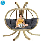 Person sitting in a hanging chair with a blue water droplet icon above it.